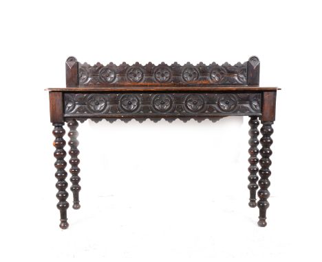 A stained oak side table, carved gallery back, single frieze drawer with similar decoration, bobbin-turned legs, width 121cm,