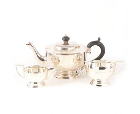 An Art Deco style three-piece silver teaset by J. Gloster Limited, Birmingham 1929, of circular form with single line decorat