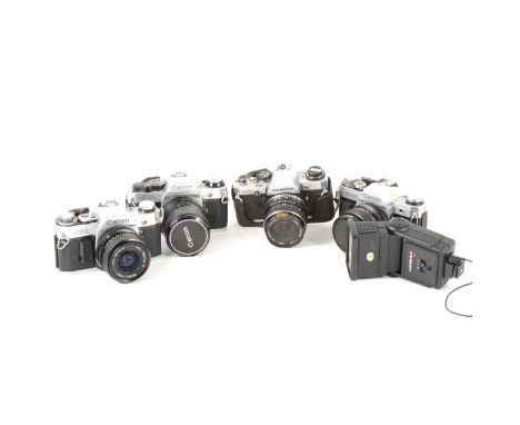 Vintage SLR cameras; four to include three Canon model AE-1 35mm cameras with selection of lenses and bags, and a Olympus OM1