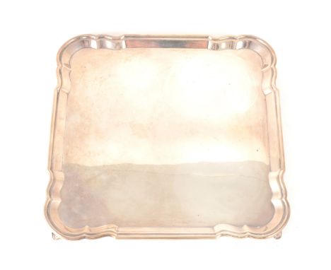 A square shape silver salver, Atkin Bros, Sheffield 1931, 25cm diameter, moulded piecrust edge supported on splayed corner fe