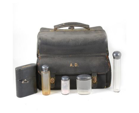 Leather travelling bag with part fitted silver-mounted glass bottle set, length 33cm.