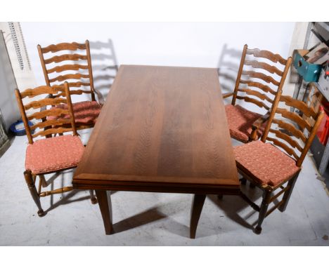 An oak dining table, rectangular top with a deep moulded edge, on shaped supports, 72cm x 102cm and a set of six beechwood wa