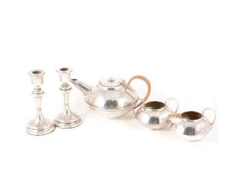 A pair of silver-filled 16cm candlesticks, Birmingham 1915, fixed sconces, a silver-plated three-piece teaset by Plato of squ