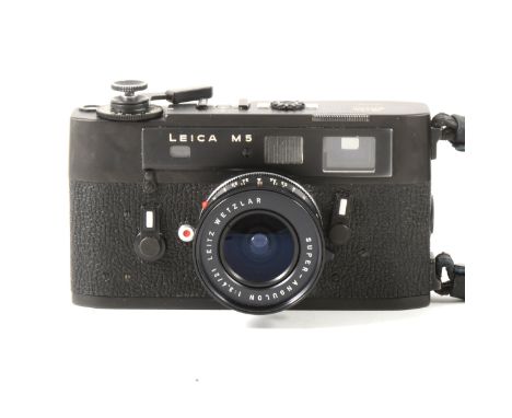 Leica M5 black rangefinder camera, with Leitz Wetslar 1:3.4/21 lens, serial number 1350756, in carry case and strap.