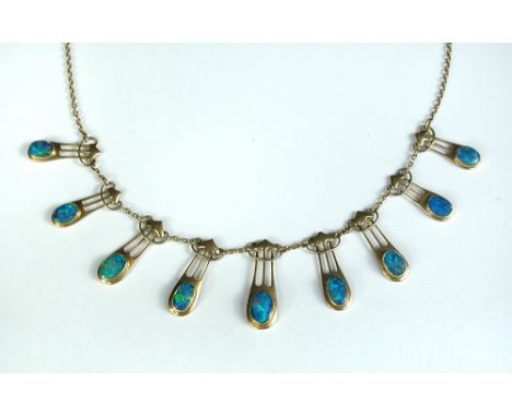 An Art Nouveau style opal fringe necklace, possibly by Murle Bennett & Co, the nine oval opal cabochons collet set in stylise