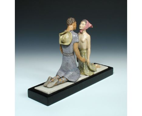 Attributed to Lenci, an Art Deco figure group, modelled as a kneeling couple about to share an embrace, she with pink polka d