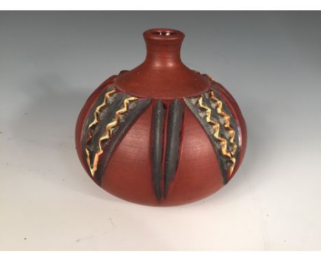 A Poole Pottery red stoneware vase by Catherine Connett, circa 1975, the thrown vessel with carved and glazed decoration, imp