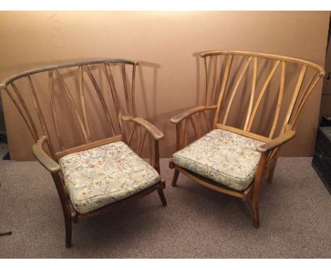 A pair of Ercol style wingback armchairs, with loose padded cushions 85 x 81cm (33 x 32in)  