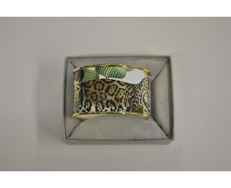 A Bilston & Battersea enamel bangle featuring leopard amongst jungle foliage, white enamel within stamped Bilston & Battersea