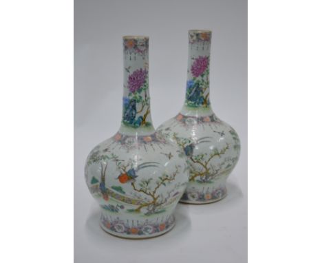 A pair of Chinese famille rose vases; each one with cylindrical neck and decorated with birds and flowers in a garden, 35.5 c