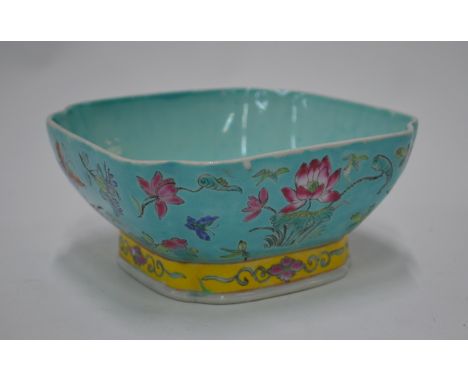 A Chinese famille rose bowl decorated with floral designs; 15 cm wide, the base with Jiaqing six-character mark but not of th