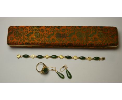 A Chinese linked bracelet having six cabochons of New Zealand jade between yellow metal stamped 14k to/w oval New Zealand jad
