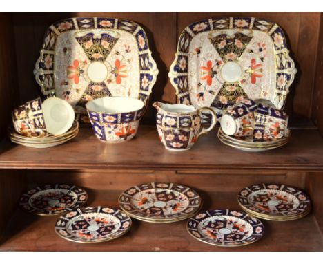 A Royal Crown Derby Imari decorated tea service, pattern 2451, comprising:  Two square twin handle sandwich plates, date 1924