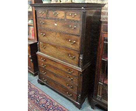 An 18th century mahogany chest on chest, the dentil moulded cornice over an arrangement of three short over seven long drawer