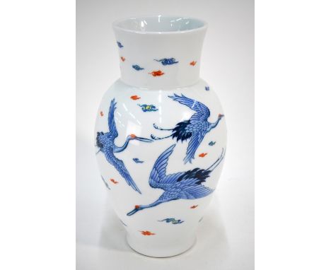 A Japanese oviform vase, decorated in underglaze blue and enamel with five red-capped Manchurian tsuru in flight beside cloud