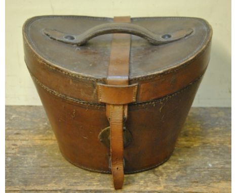 A vintage tan leather hat box lined in padded puce silk, a paint decorated tin hat box with brass crested plaque to front for