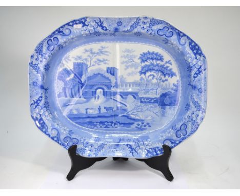 An early 19th century Spode pearlware blue and white transfer decorated meat plate incorporating a gravy well, 'Castle' patte