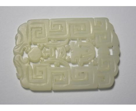 A Chinese green jade pendant of whitish hue, designed with a key-fret pattern and reticulated motifs, about 4.5 x 3 cm, post 
