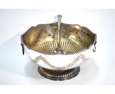 A large electroplated on copper punch bowl with lion mask and ring handles, embossed and chased with rose garlands, on reeded