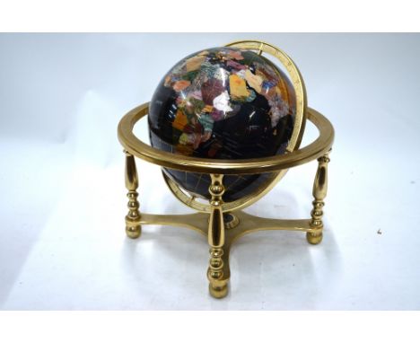 A black enamelled table globe, inset with wire cloissonnes, polished hardstones and mother-of-pearl, revolving on a brass-pla