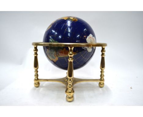 A blue enamelled table globe, inset with wire cloissonnes, polished hardstones and mother-of-pearl, revolving on a brass-plat