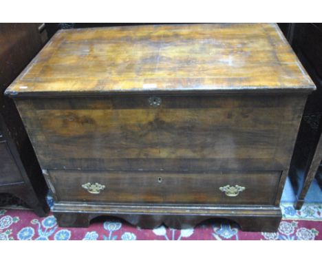 An 18th century fruitwood mule trunk, the quarter veneered cross-banded hinged top over a full width drawer, raised on shaped
