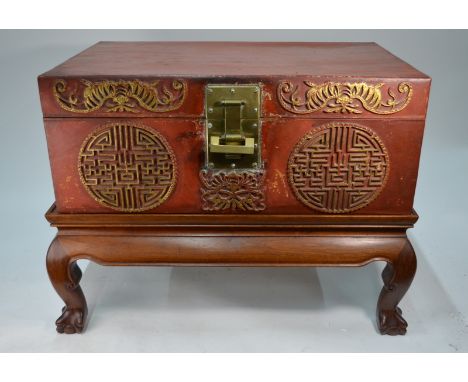 A Chinese old red lacquered trunk with shou or other motifs and a  gilt metal lock and fitting, 75 cm wide x 30 cm high x 48 