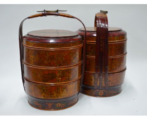 An associated pair of circular and tiered boxes, possibly Chinese picnic or wedding boxes; each one decorated with narrative 