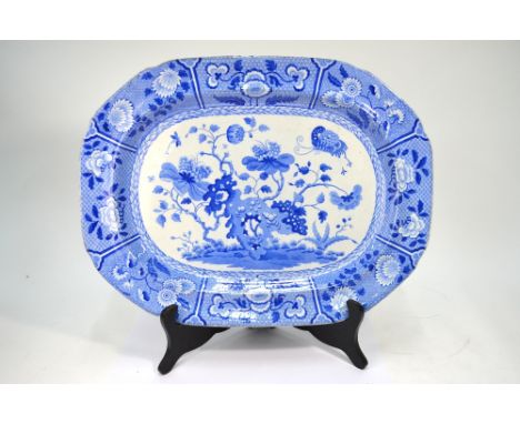 An early 19th century Spode blue and white meat plate, transfer decorated in the Chinoiserie style with rockwork, flowers and