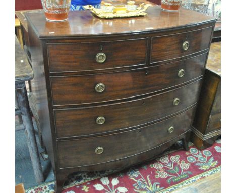 A Victorian mahogany bowfront chest of two short over three long graduated drawers, raised on splayed bracket feet united by 
