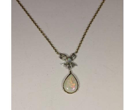 An opal and diamond pendant, with brilliant cut diamond set knotted bow set with a round cabochon opal to the centre, and a c