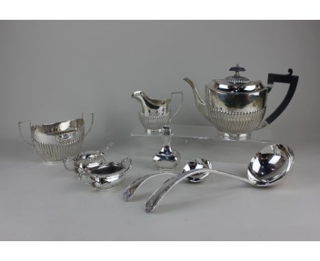 A silver plated three-piece tea set of demi fluted oval form, three-piece cruet set, soup ladle and a matching sauce ladle