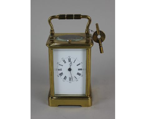 A 19th century French brass repeater carriage clock striking on a gong, the white enamel dial with Roman numerals and Arabic 