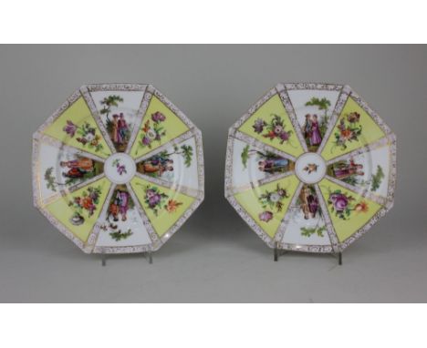 A pair of Dresden porcelain octagonal plates decorated with panels of courting couples and flowers on yellow ground, with gil