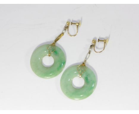 A pair of jade disc drop earrings set in yellow metal with screw fittings