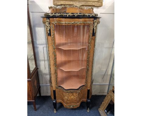 A Louis XV style kingwood vitrine with caddy top and serpentine glazed door enclosing three shaped shelves and glazed panel s