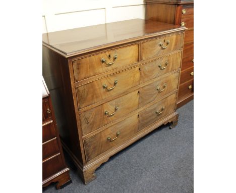 A George III mahogany chest of two short over three long graduated drawers with brass swing handles on bracket feet 101cm (a/
