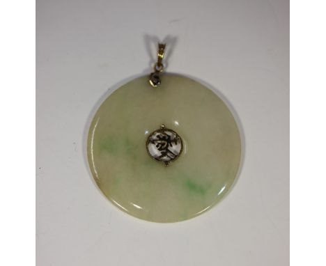 A 14ct gold mounted Chinese jade disc pendant