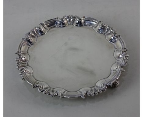 A Victorian silver circular card dish with pie crust border on three scroll feet, maker Wm Hutton &amp; Sons, London 1896, 15