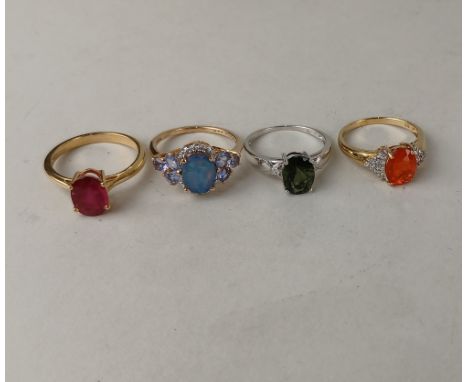 An opal doublet cluster ring with tanzanite shoulders, and three other gem-set rings, all in 9ct gold