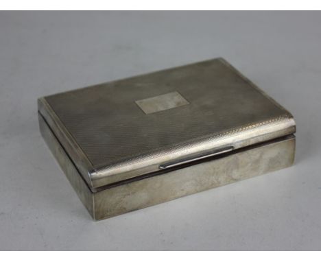 A modern silver cigarette box with engine turned hinged lid , vacant central panel, Birmingham 1967, 11cm