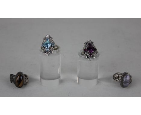 A silver and tiger's eye ring, a silver and agate ring and two costume jewellery rings 