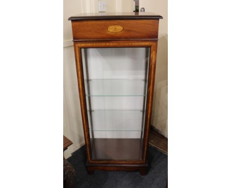 An Edwardian style mahogany display cabinet with glazed sides and banded glazed panel door enclosing two adjustable glass she