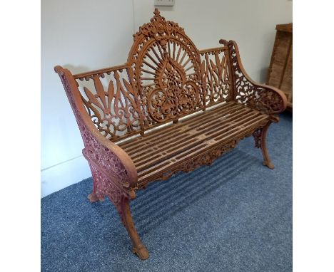 A cast iron garden bench with pierced decoration and slatted iron seat on outswept legs 118cm *This item is very heavy and mu