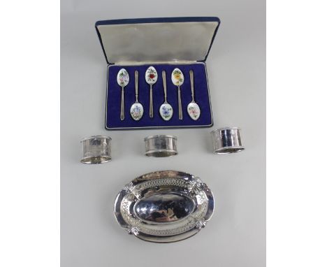 A George V silver pierced oval dish Birmingham 1924, a pair of 84 silver napkin rings, a single napkin ring and a cased set o