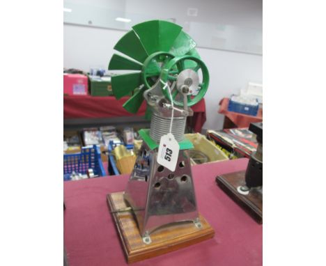 A Sterling Hot Air Engine Vertical Cylinder, 25mm stroke 6.5cm flywheel to one side, twelve vane windmill to other, plus burn