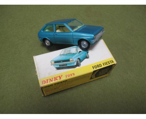 A Dinky Toys (Made in Spain) #011541 Diecast Model Ford Fiesta. metallic light blue body, cream interior, original picture bo