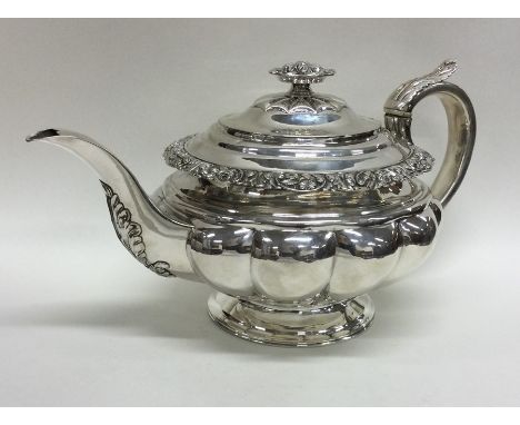 A good Georgian silver teapot of shaped form embossed with flowers and leaves to pedestal foot. London. By WP? Approx. 654 gr