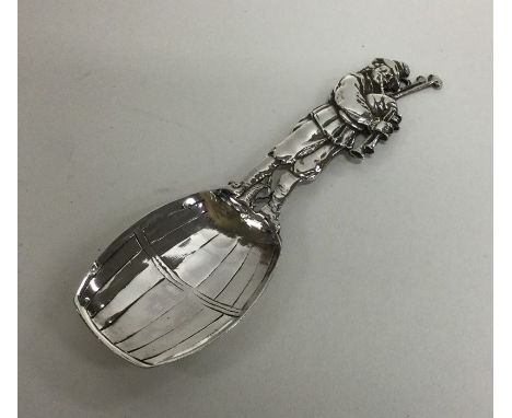A 19th Century Dutch silver caddy spoon in the form of a musician stood upon a barrel. Import marks for Chester, 1899. Approx