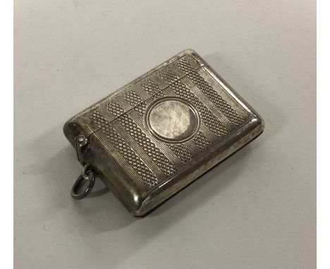 An engine turned silver vesta case with hinged top. London. Approx. 32 grams. Est. £20 - £30.